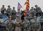 American Soldiers from the 56th Stryker Brigade Combat Team, Pennsylvania Army National Guard, and soldiers from the Republic of North Macedonia by their tactical vehicles to show unity between the two nations, following the Exercise Decisive Strike’s opening ceremony at the Training Support Centre Krivolak , North Macedonia, June 5, 2019.
