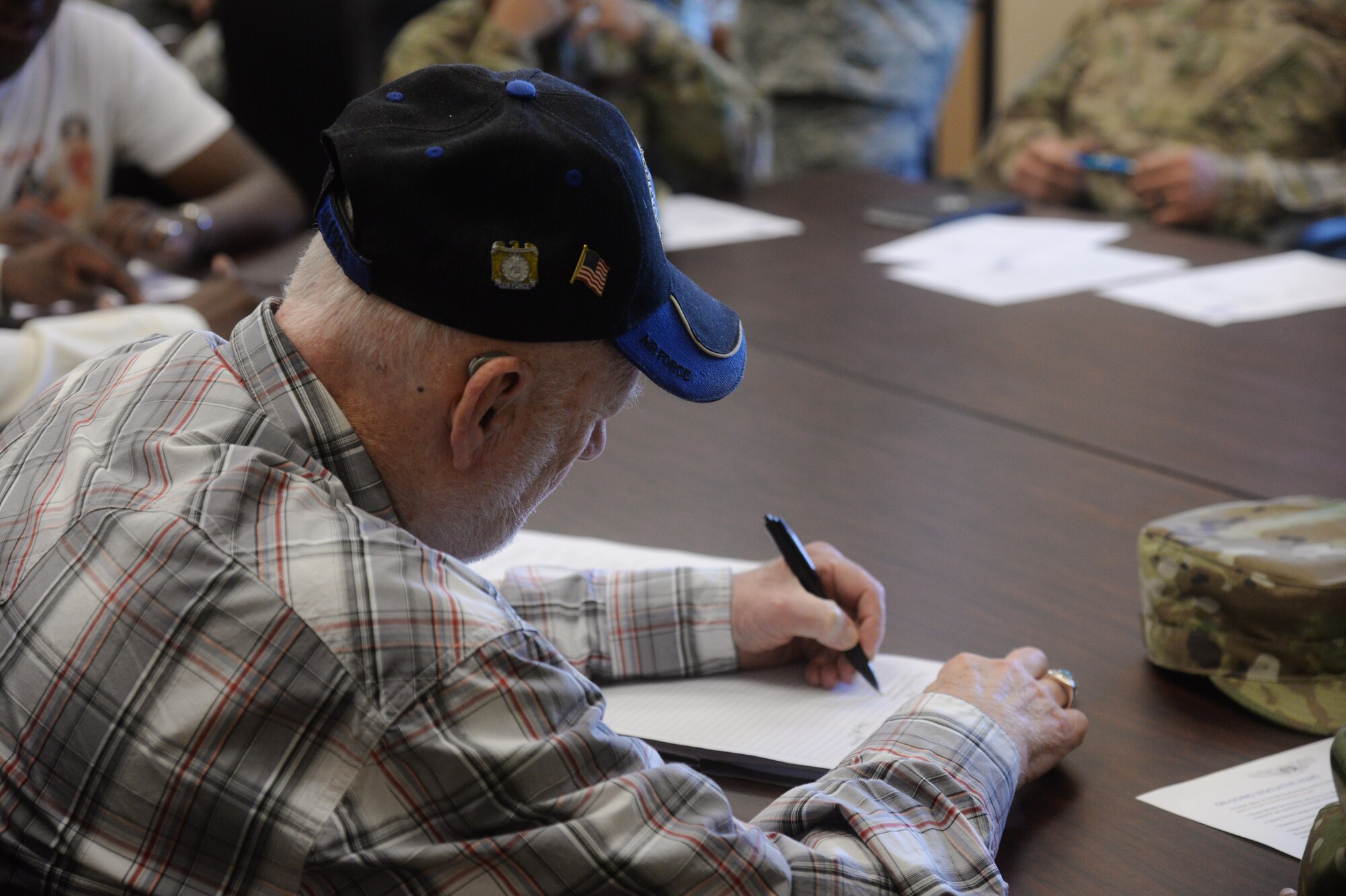 Jim Simmonds, Air Force Sergeants Association recruiter, fills out a document during a meeting July 10, 2019, at Malmstrom Air Force Base, Mont.