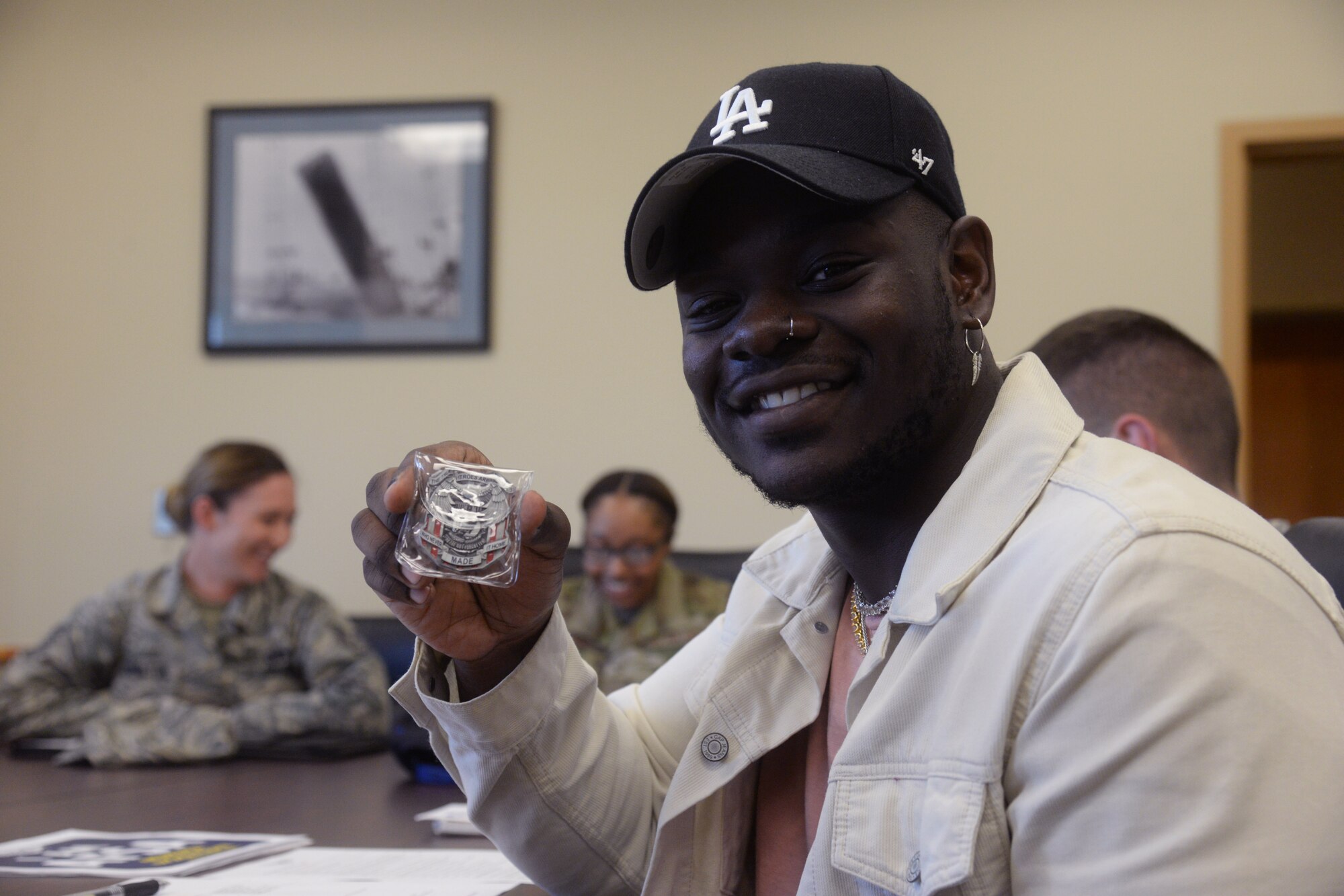A member of the Air Force Sergeants Association poses with a coin July 10, 2019, at Malmstrom Air Force Base, Mont.