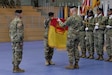 U.S. Army Brig. Gen. Christopher LaNeve, left, the commanding general of the 7th Army Training Command observes as U.S. Army Col. Seth Knazovich, right, commander of the 41st Field Artillery Brigade, and U.S. Army Command Sgt. Maj. Samuel Zoker, middle, Command Sgt. Maj. of the 41st Field Artillery Bde., uncase the unit colors during the unit’s activation ceremony in Grafenwoehr, Germany, Nov. 30, 2018. The 41st Field Artillery Bde. “Railgunners” is the new unit activating in Grafenwoehr, Germany under the training readiness authority of 7th ATC and will provide long-range precision fires capabilities for U.S. Army Europe. (U.S. Army photo by Spc. Emily Houdershieldt)