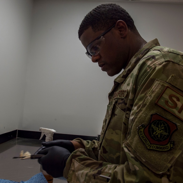 Staff Sgt. Rossitor Alexander, an instructor assigned to the 628th Security Forces Squadron Combat Arms Training and Maintenance flight, cleans an M9 pistol at Joint Base Charleston, S.C. July 1, 2019. CATM facilitates readiness by equipping Airmen with the knowledge and skills to use weapons properly, and provides support to local and regional military branches. CATM instructors qualify for the weapons annually to maintain proficiency.