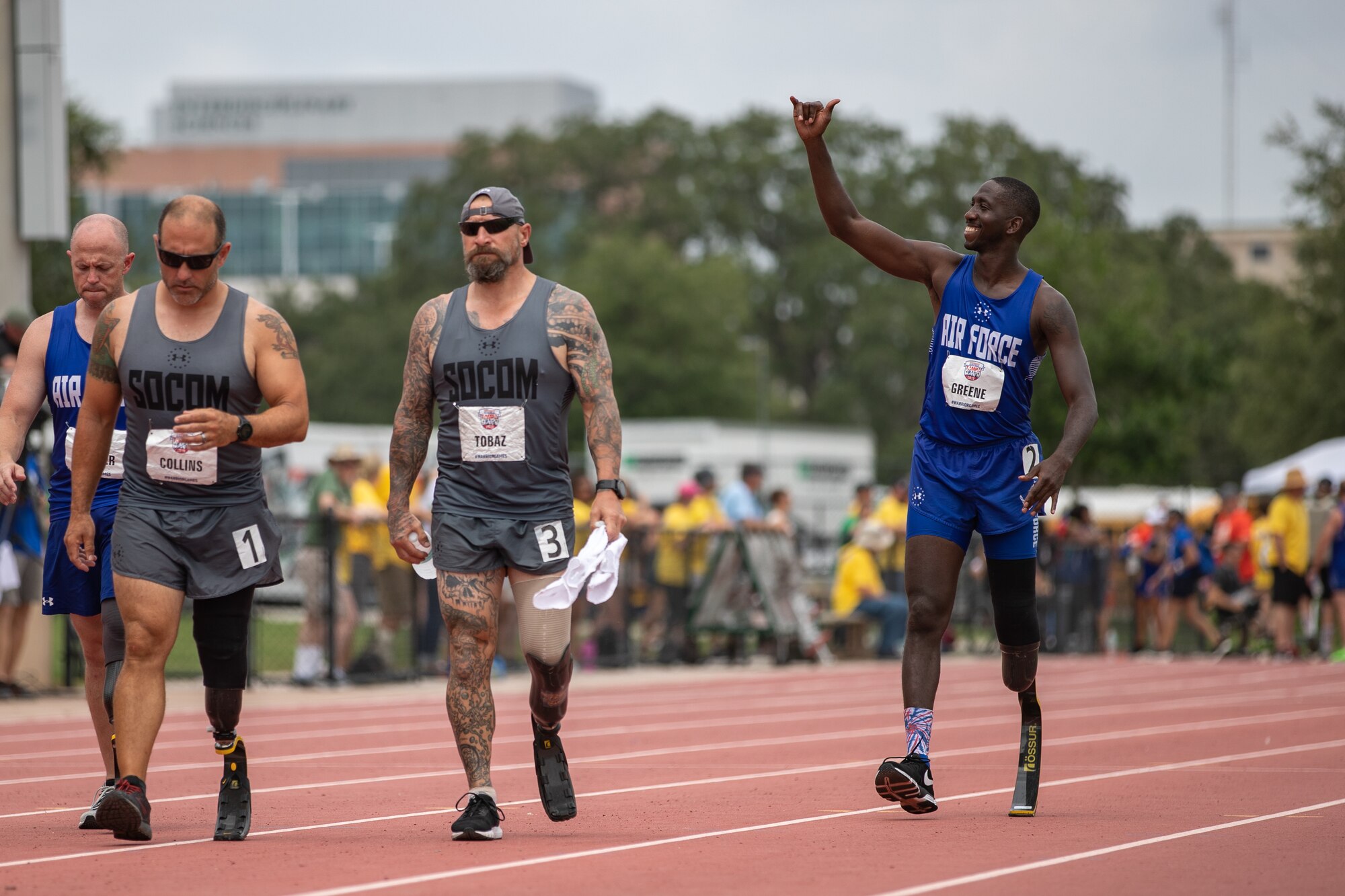 Air Force Reserve, Staff Sgt. Kevin Greene waves to his family in the stands as he walks to his starting position for the 800 meter race at the 2019 DoD Warrior Games.  Warrior Games is a Paralympic style sporting event with 300 athletes from all DoD service branches and five international coalition partners.  Active duty and veteran wounded warriors compete in 13 adaptive sports to inspire recovery, support rehabilitation and generate a wider understanding and respect of those who serve their country