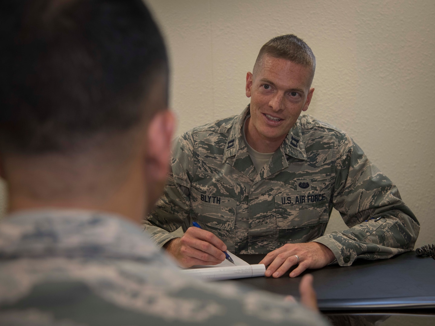 Capt. Matthew Blyth, a Defense Attorney with the Air Force Legal Operations Agency/Area Defense Council assists a troubled Airman July 10, 2019 at the Joint Base San Antonio-Randolph ADC. The ADC is a full-spectrum resource, implemented in 1974, to help Airmen through the lowest level paperwork, such as a letter of counseling or a letter of reprimand, up to the most serious court martial cases. (U.S. Air Force photo by: Airman 1st Class Shelby Pruitt)