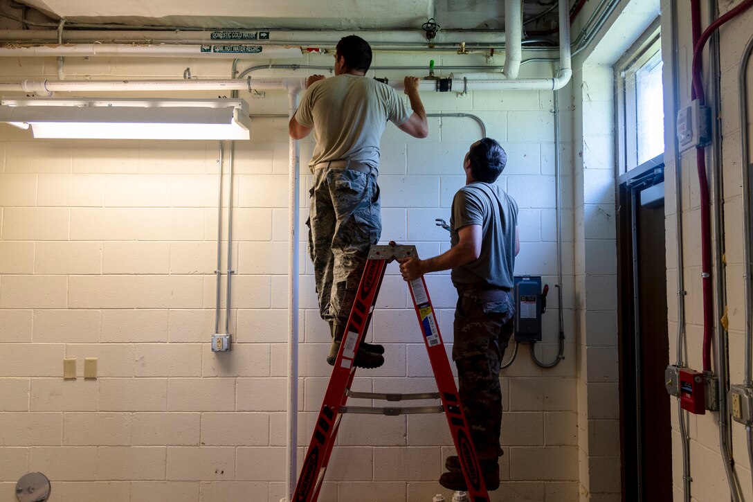 Staff Sgt. Joseph Dickerson, left, and Staff Sgt. Daniel Champion, right, both 23d Civil Engineer Squadron (CES) water and fuel systems maintenance craftsman, inspect a wall, July 2, 2019, at Moody Air Force Base, Ga. Airmen from the 23d CES Water and Fuels Systems Maintenance are on-call 24/7 to sustain and maintain the base, water, sewer and gas lines and upkeep of the 696 facilities with water and fuel infrastructure. (U.S. Air Force photo by Airman 1st Class Taryn Butler)