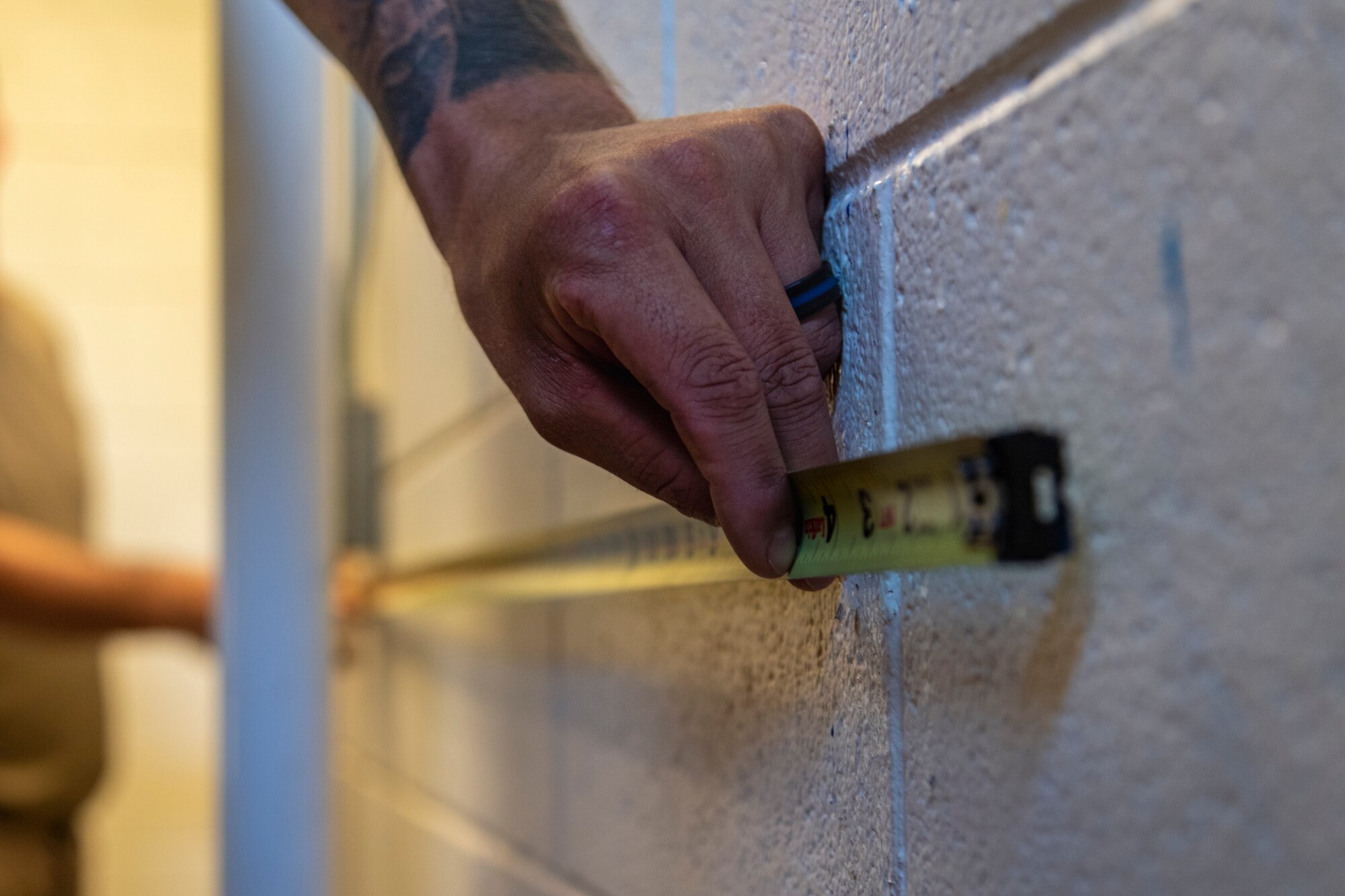 Airmen from the 23d Civil Engineer Squadron (CES) Water and Fuels Systems Maintenance shop measure a wall, July 2, 2019, at Moody Air Force Base, Ga. Airmen from the 23d CES Water and Fuels Systems Maintenance are on-call 24/7 to sustain and maintain the base, water, sewer and gas lines and upkeep of the 696 facilities with water and fuel infrastructure. (U.S. Air Force photo by Airman 1st Class Taryn Butler)