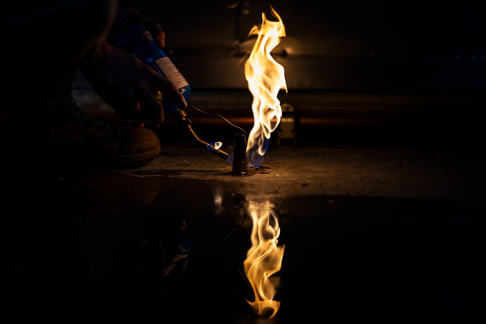 An Airman from the 23d Civil Engineer Squadron (CES) Water and Fuels Systems Maintenance shop solder a copper pipe to a fitting, July 2, 2019, at Moody Air Force Base, Ga. Airmen from the 23d CES Water and Fuels Systems Maintenance are on-call 24/7 to sustain and maintain the base, water, sewer and gas lines and upkeep of the 696 facilities with water and fuel infrastructure. (U.S. Air Force photo by Airman 1st Class Taryn Butler)