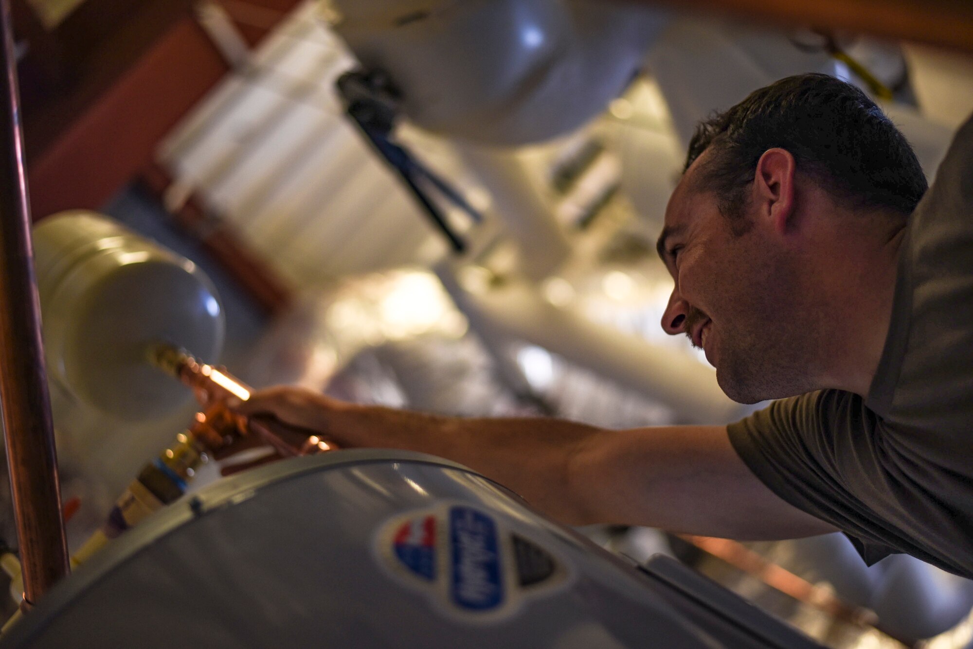Staff Sgt. Daniel Champion, 23d Civil Engineer Squadron (CES) water and fuel systems maintenance craftsman, places an expansion tank, on a water heater, July 2, 2019, at Moody Air Force Base, Ga. Airmen from the 23d CES Water and Fuels Systems Maintenance are on-call 24/7 to sustain and maintain the base, water, sewer and gas lines and upkeep of the 696 facilities with water and fuel infrastructure. (U.S. Air Force photo by Airman 1st Class Taryn Butler)