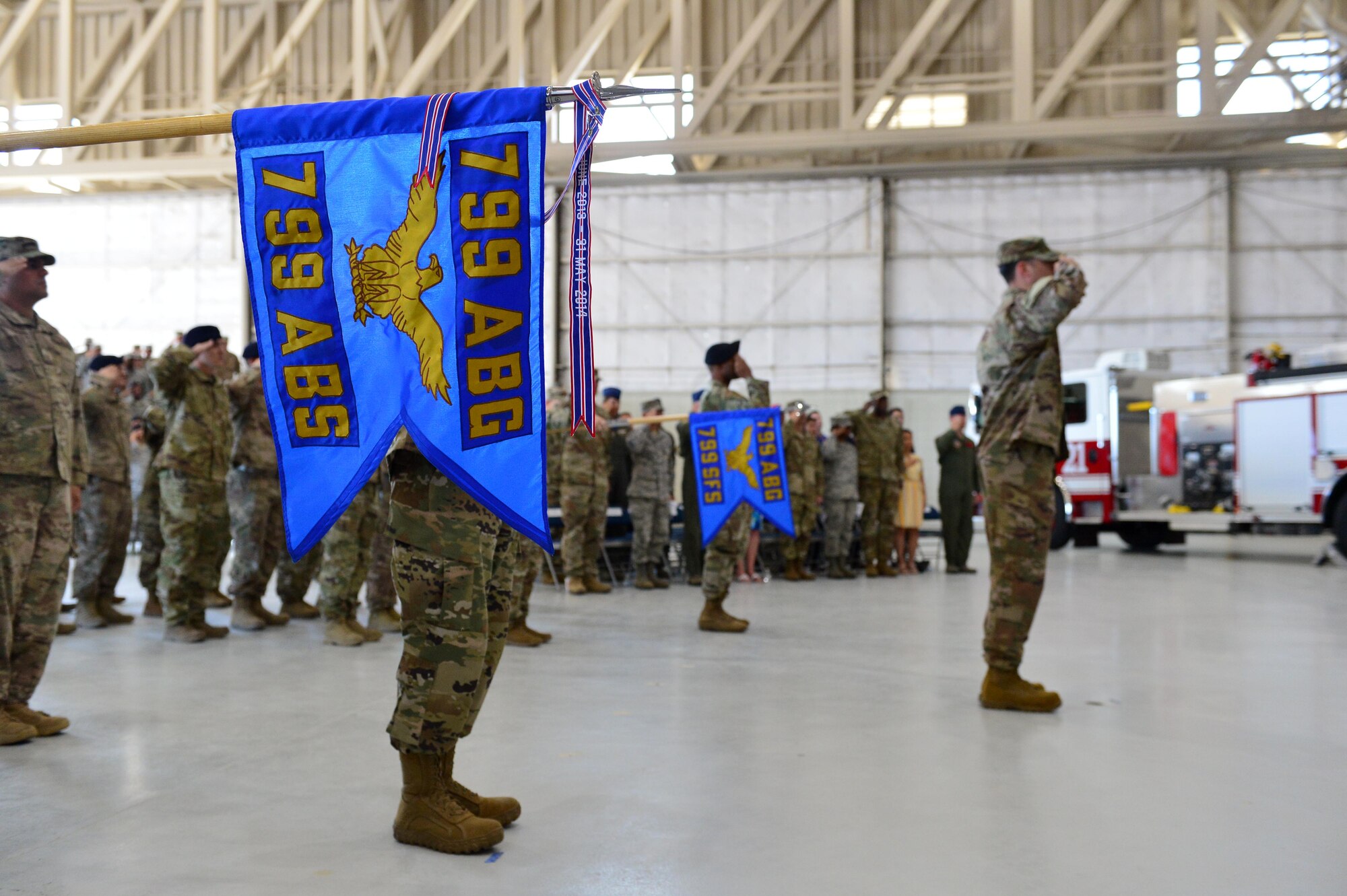 The 799th Air Base Squadron flag is presented for The National Anthem, during the 432nd Mission Support Group activation ceremony at Creech Air Force Base, Nevada, July 11, 2019. Standing up a mission support group for the 432nd Wing was among the first steps to prepare the wing to take installation command. (U.S. Air Force photo by Senior Airman Haley Stevens)