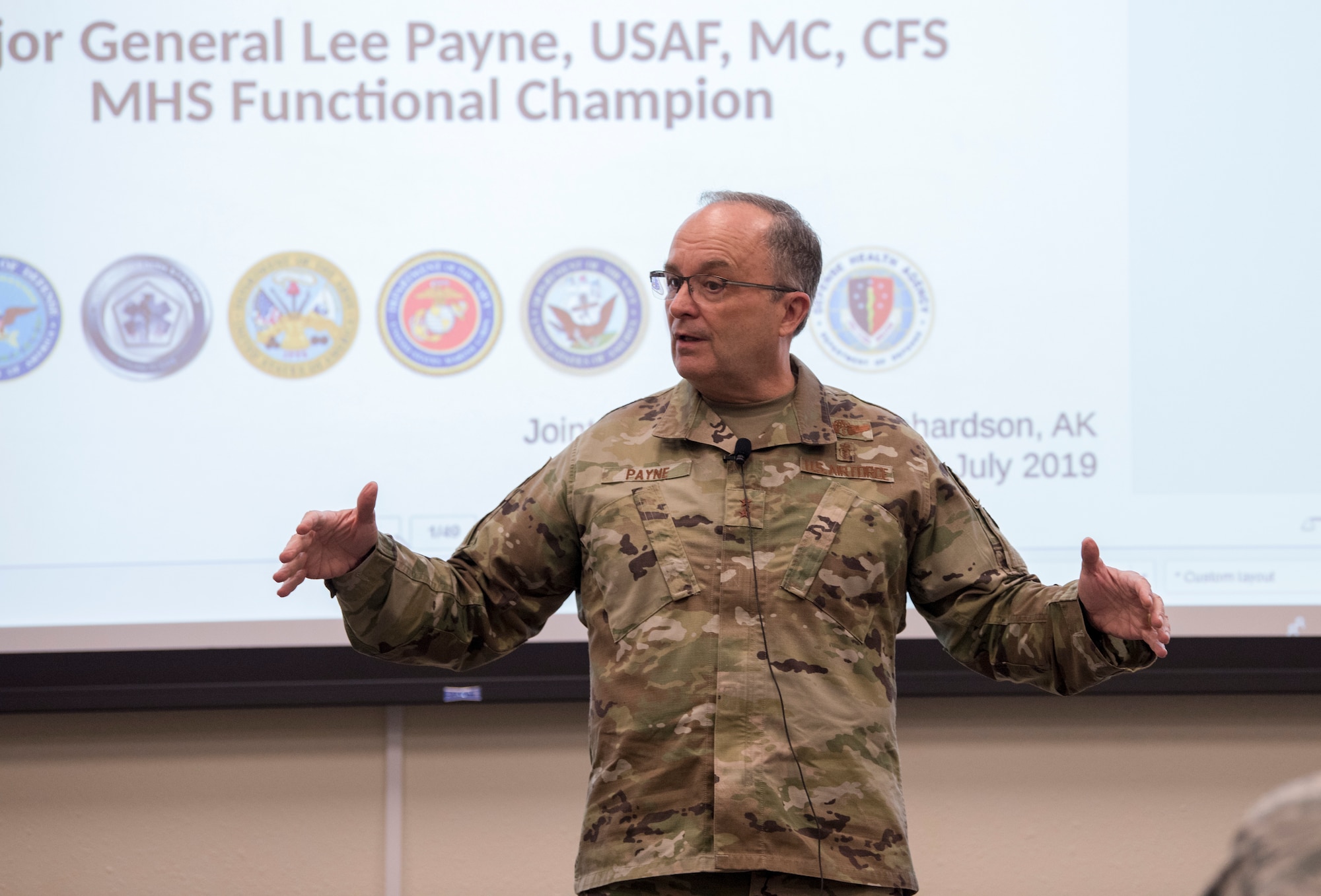 U.S. Air Force Maj. Gen. Lee E. Payne, Defense Health Agency Assistant Director for Combat Support, and Military Health System Electronic Health Record Functional Champion, briefs Joint Base Elmendorf-Richardson’s medical personnel during his visit at JBER, Alaska, July 9, 2019. Payne discussed upcoming changes to MHS and what that means for patients and providers.