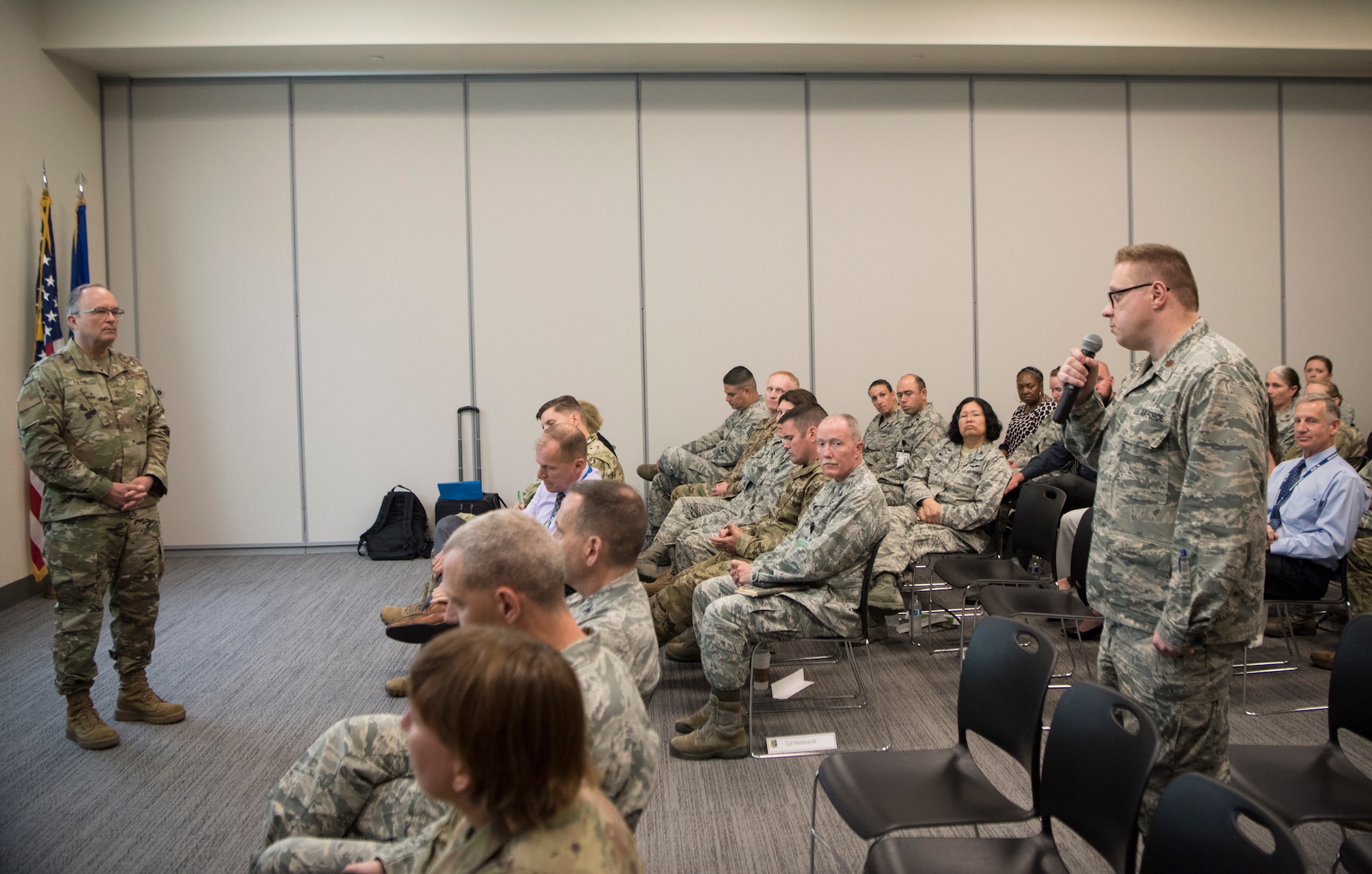 U.S. Air Force Maj. David Taylor, 673d Medical Group otolaryngologist, asks a question to U.S. Air Force Maj. Gen. Lee E. Payne, Defense Health Agency Assistant Director for Combat Support, and Military Health System Electronic Health Record Functional Champion, during his visit at Joint Base Elmendorf-Richardson, Alaska, July 9, 2019. Payne discussed upcoming changes to MHS and what that means for patients and providers.