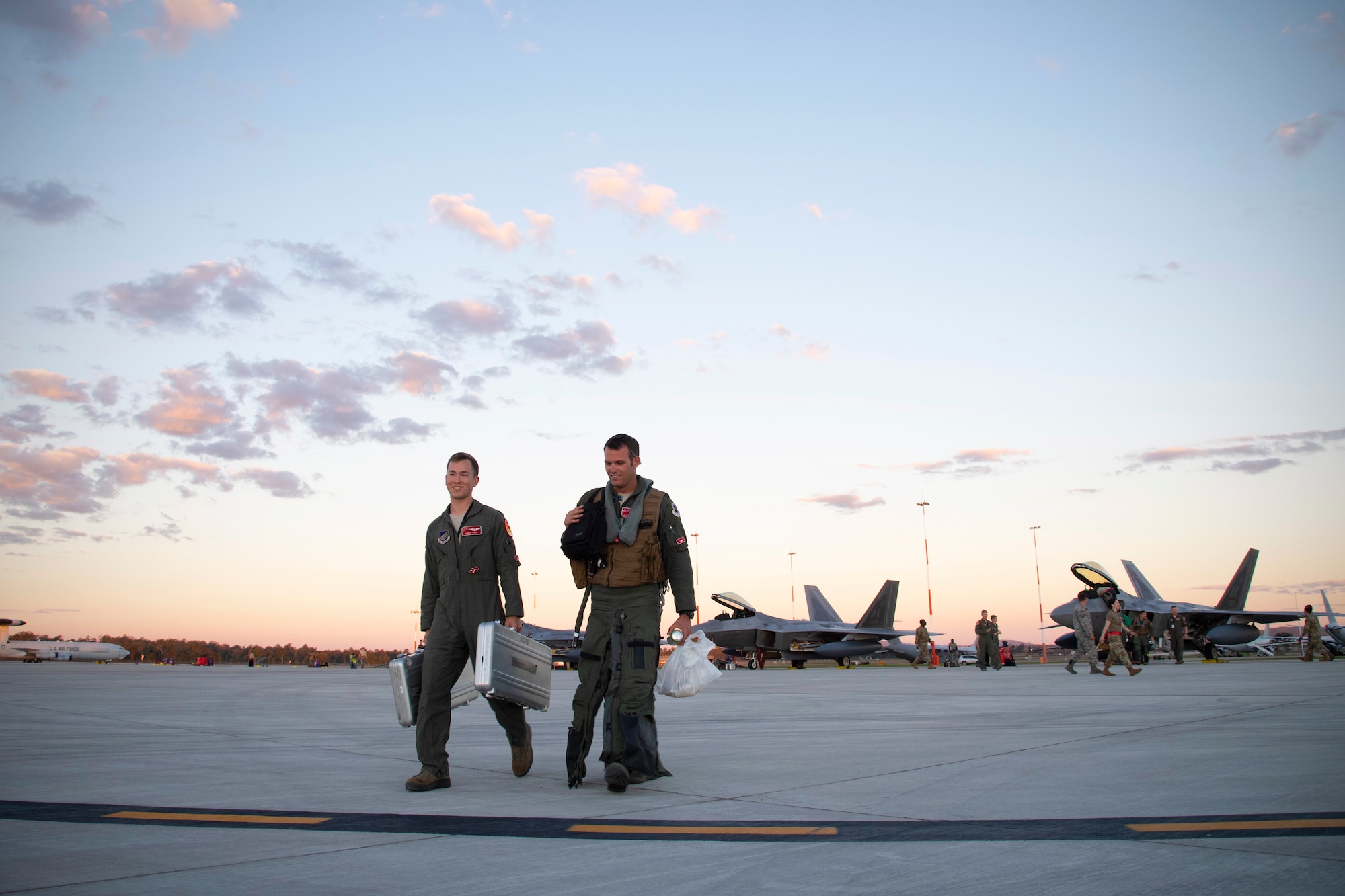 U.S. Air Force Lt. Col. Ryan Graf, 90th Fighter Squadron commander, right, and USAF Capt. Jonathan Weed, with the 90 FS, Joint Base Elmendorf-Richardson, Alaska, depart the flightline after arriving July 9, to Royal Australian Air Force Base Amberley, Australia, in support of Talisman Sabre 19. Talisman Sabre is a month-long exercise along the east coast of Australia that incorporates force members from Australia and the United States in amphibious landings, land force maneuver, urban operations, air operations, maritime operations and special forces activities. (U.S. Air Force photo by Senior Airman Elora J. Martinez)