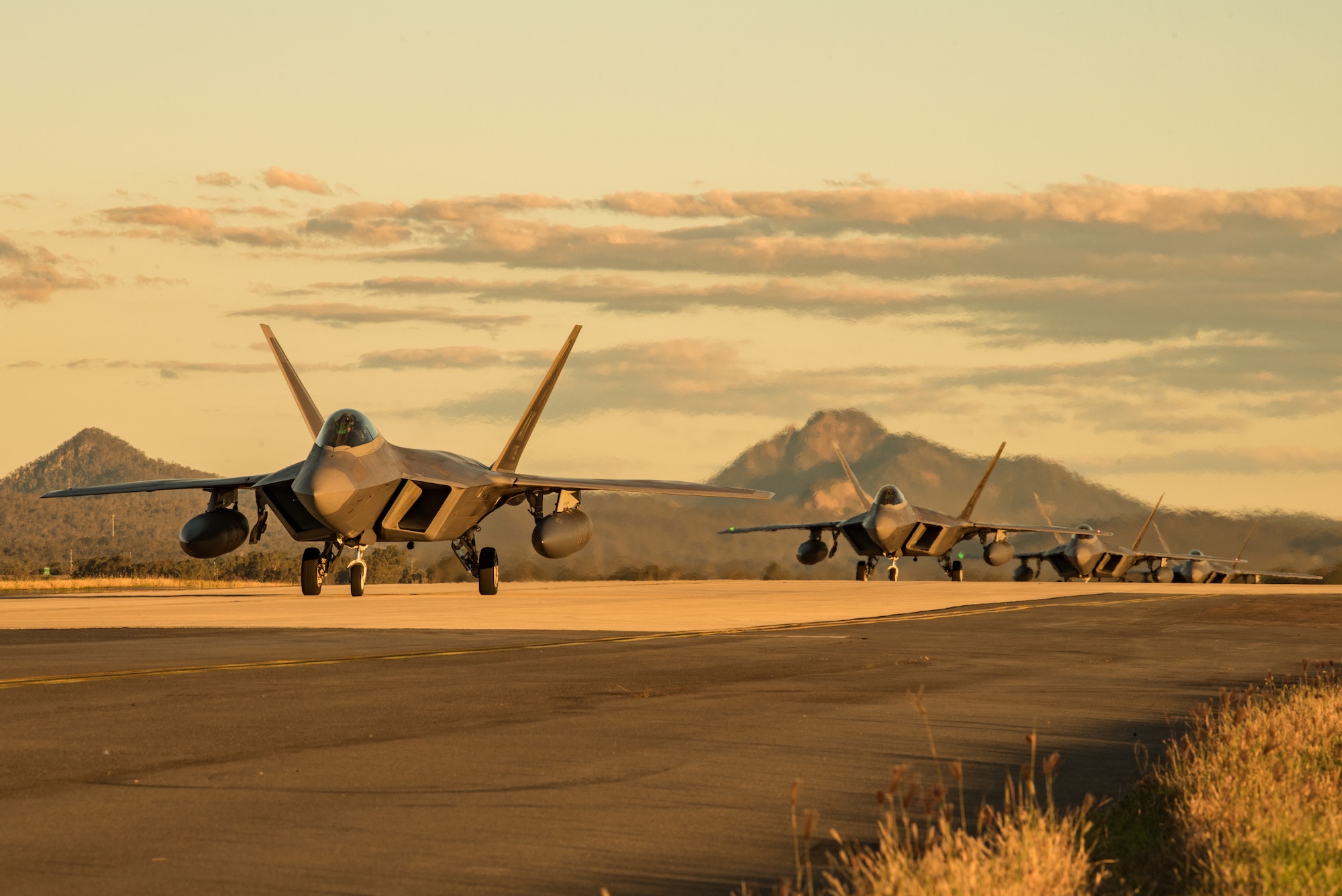 F-22 Raptors assigned to the 90th Fighter Squadron, Joint Base Elmendorf-Richardson, Alaska, taxi to their parking location at the Royal Australian Air Force Base Amberley flightline for Talisman Sabre 19, July 9. Talisman Sabre provides effective and intense training to ensure U.S. Forces are combat ready, capable, interoperable, and deployable on short notice. (U.S. Air Force photo by Staff Sgt. Kyle Johnson)