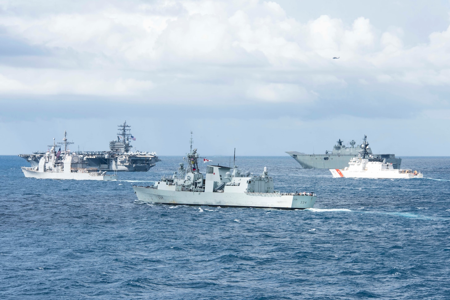 190711-N-DX072-1052 TASMAN SEA (July 11, 2019) The U.S. Navy Nimitz-class aircraft carrier USS Ronald Reagan (CVN 76), top left, the U.S. Navy Ticonderoga-class guided-missile cruiser USS Chancellorsville (CG 62), left, the Royal Canadian Navy Halifax-class frigate HMCS Regina (FFH 334), center, the Royal Australian Navy Canberra-class landing helicopter dock ship HMAS Canberra (L02), top right, and the Legend-class cutter USCGC Stratton (WMSL 752), right, transit by the amphibious transport dock ship USS Green Bay (LPD 20) in a photo exercise (PHOTOEX) during Talisman Sabre 2019. Green Bay, part of the Wasp Expeditionary Strike Group, with embarked 31st Marine Expeditionary Unit, is currently participating in Talisman Sabre 2019 off the coast of Northern Australia. A bilateral, biennial event, Talisman Sabre is designed to improve U.S. and Australian combat training, readiness and interoperability through realistic, relevant training necessary to maintain regional security, peace and stability.