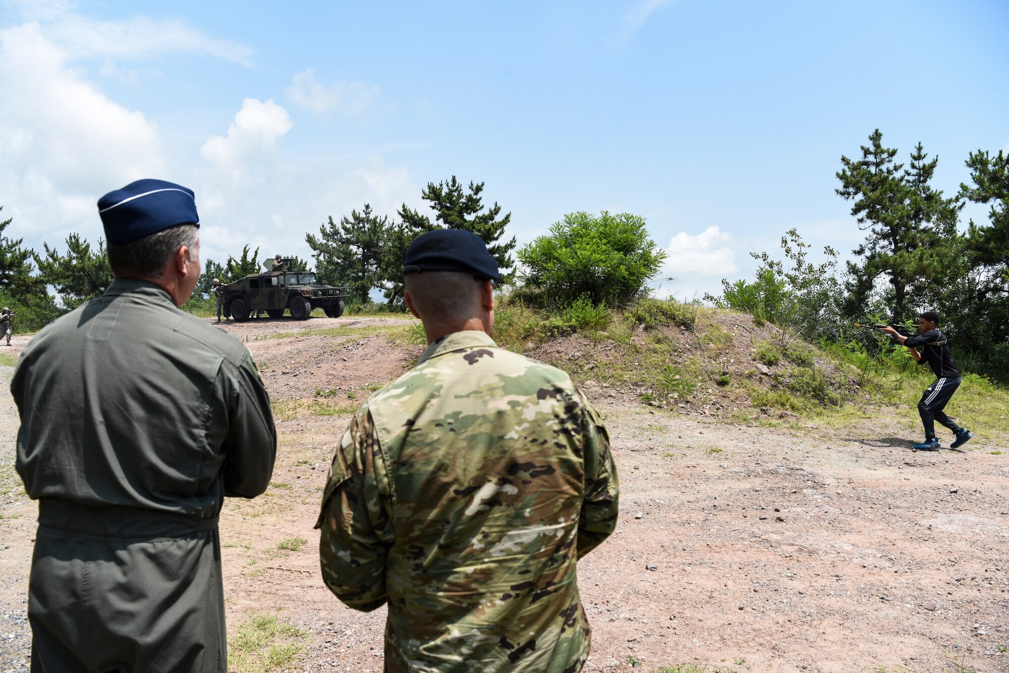U.S. Air Force Brig. Gen. David Eaglin (left), 7th Air Force vice commander, and Lt. Col. Eric Horst, 8th Security Forces Squadron commander, observe a force-on-force demonstration during an immersion tour at Kunsan Air Base, Republic of Korea, July 12, 2019. Eaglin saw how the 8th SFS is ready to fulfill their critical role of defending the base. (U.S. Air Force photo by Staff Sgt. Joshua Edwards)