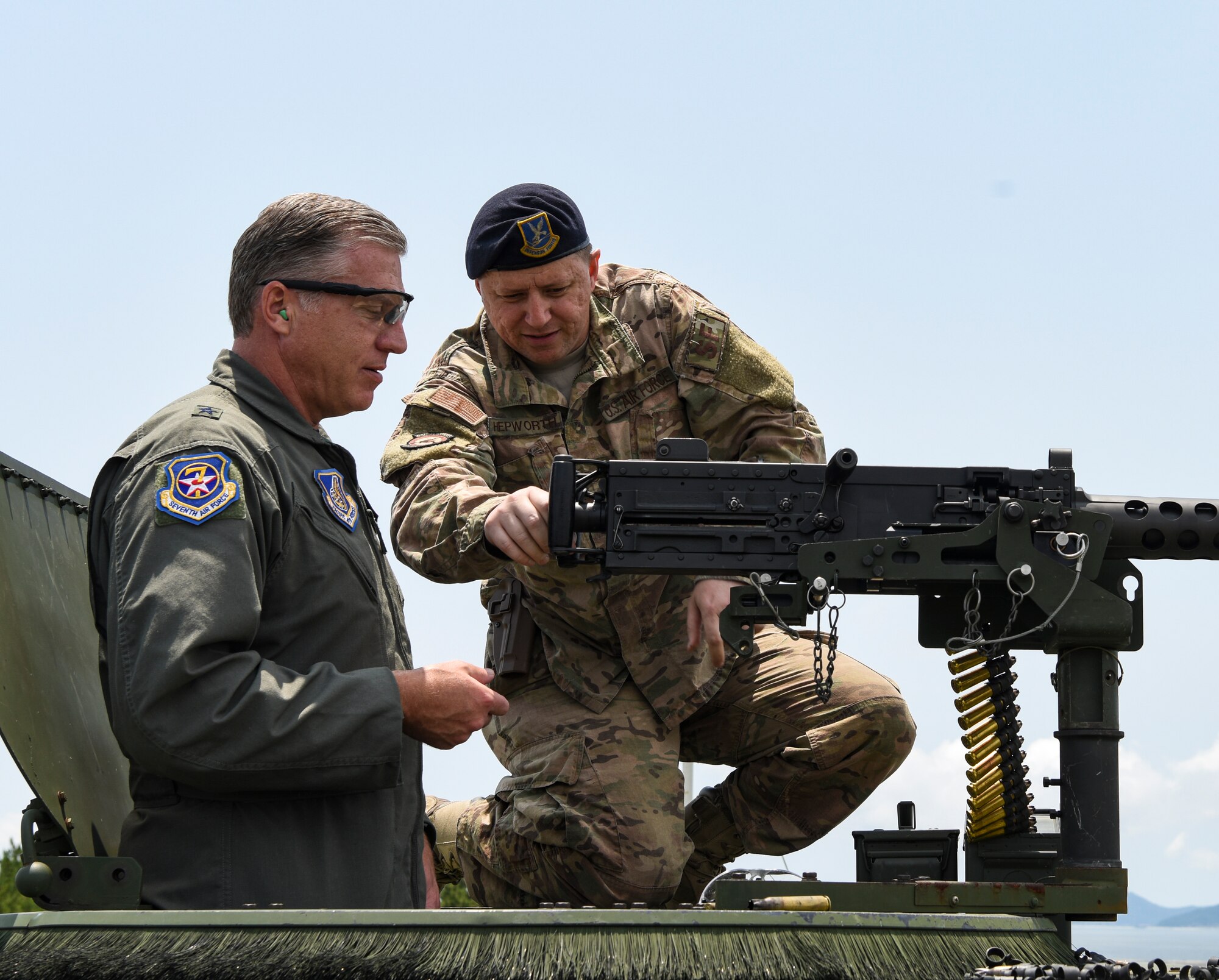 U.S. Air Force Brig. Gen. David Eaglin (left), 7th Air Force vice commander, receives instructions from Staff Sgt. Jared Hepworth, 8th Security Forces Squadron member, during an immersion tour at Kunsan Air Base, Republic of Korea, July 12, 2019. Eaglin had the opportunity to sample some of the weaponry the 8th SFS uses to defend the base. (U.S. Air Force photo by Staff Sgt. Joshua Edwards)