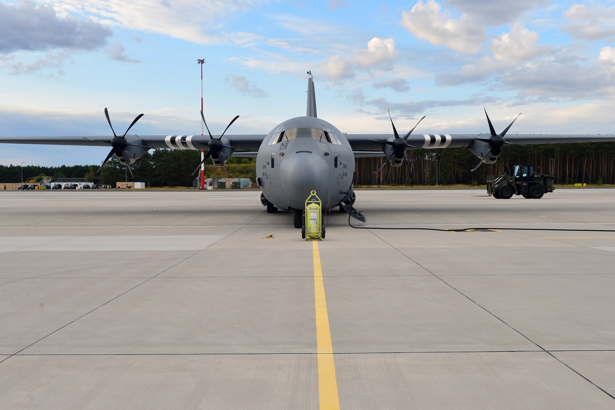 A C-130J Super Hercules assigned to the 37th Airlift Squadron sits on the flightline before takeoff at Powidz Air Base, Poland, July 10, 2019. Aviation Rotation is a continuing bilateral training exercise between the U.S. and Polish air forces to increase partnership capacities. (U.S. Air Force photo by Staff Sgt. Jimmie D. Pike)