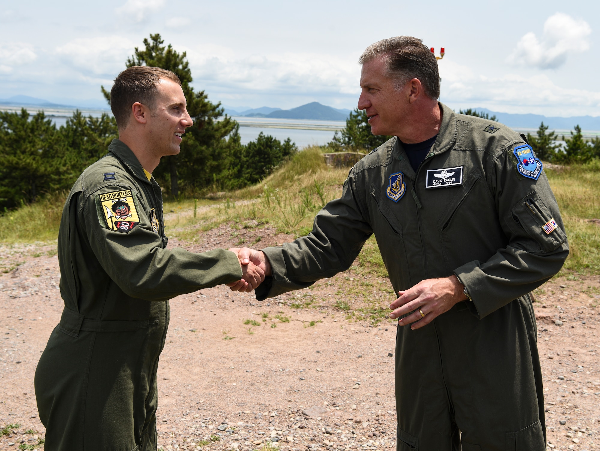 U.S. Air Force Brig. Gen. David Eaglin (right), 7th Air Force vice commander, coins Capt. Andrew Marty, 80th Fighter Squadron pilot, during an immersion tour at Kunsan Air Base, Republic of Korea, July 12, 2019. Eaglin introduced himself and recognized some of the Airmen from the Wolf Pack for their professionalism and readiness. (U.S. Air Force photo by Staff Sgt. Joshua Edwards)