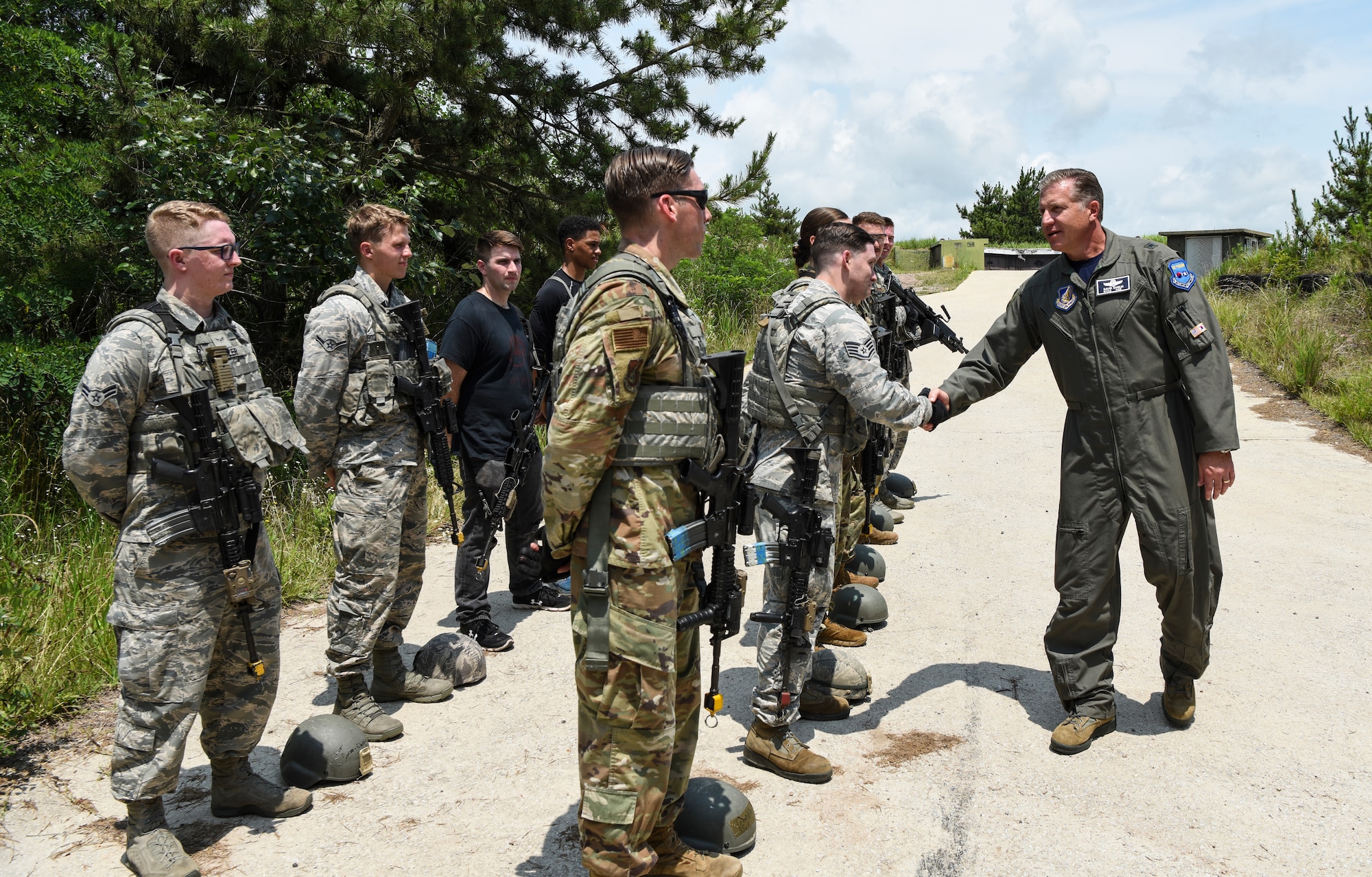 U.S. Air Force Brig. Gen. David Eaglin (right), 7th Air Force vice commander, shakes hands with members from the 8th Security Forces Squadron during an immersion tour at Kunsan Air Base, Republic of Korea, July 12, 2019. Eaglin introduced himself and recognized some of the Airmen from the Wolf Pack for their professionalism and readiness. (U.S. Air Force photo by Staff Sgt. Joshua Edwards)