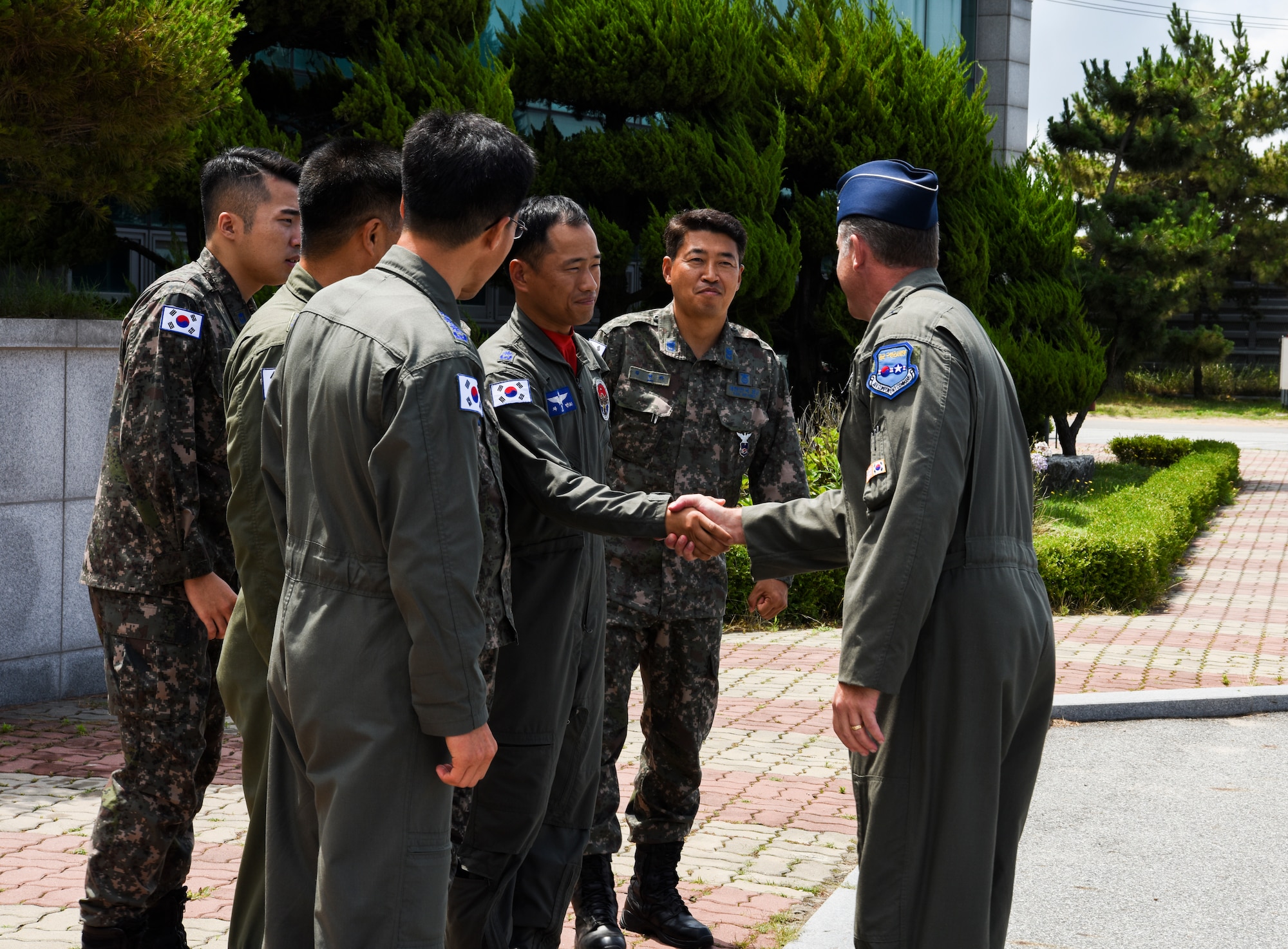 U.S. Air Force Brig. Gen. David Eaglin (right), 7th Air Force vice commander, shakes hands with 38th Fighter Group leadership July 12, 2019, at Kunsan Air Base, Republic of Korea. Eaglin visited Kunsan, to get a chance to see first-hand the capabilities the Wolf Pack and Republic of Korea Air Force bring to the table. (U.S. Air Force photo by Staff Sgt. Joshua Edwards)