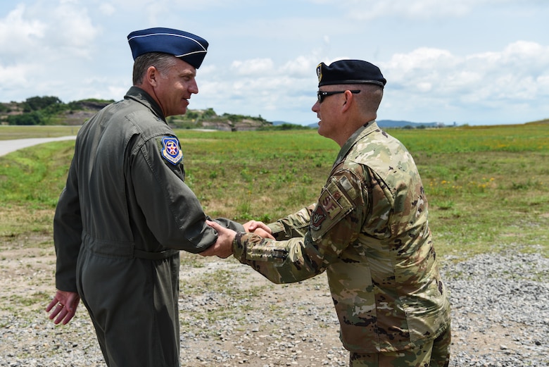 U.S. Air Force Brig. Gen. David Eaglin (left), 7th Air Force vice commander, shakes hands with Lt. Col. Eric Horst, 8th Security Forces Squadron commander, during an immersion tour at Kunsan Air Base, Republic of Korea, July 12, 2019. Eaglin saw how the 8th SFS is ready to fulfill their critical role of defending the base. (U.S. Air Force photo by Staff Sgt. Joshua Edwards)