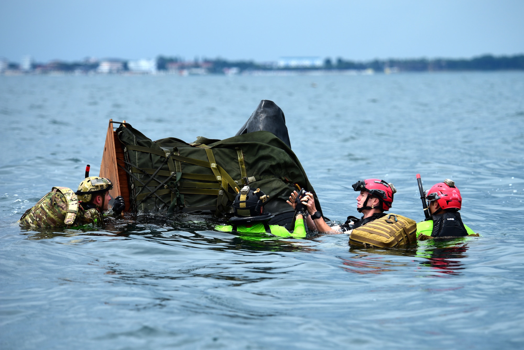 U.S. Air Force pararescuemen assigned to the 57th Rescue Squadron prepare a rigged alternate method zodiac (RAMZ) during over-water parachute training off the coast of Italy, July 9, 2019. The RAMZ is an inflatable, motorized boat that is airdropped alongside jumpers into the water. (U.S. Air Force photo by Staff Sgt. Kelsey Tucker)
