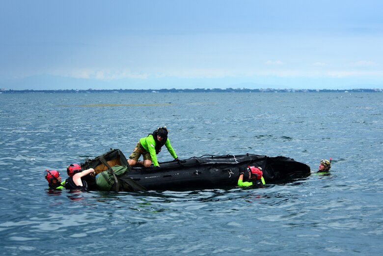 U.S. Air Force pararescuemen assigned to the 57th Rescue Squadron prepare a rigged alternate method zodiac (RAMZ) during over-water parachute training off the coast of Italy, July 9, 2019. The RAMZ is an inflatable, motorized boat that is airdropped alongside jumpers into the water. (U.S. Air Force photo by Staff Sgt. Kelsey Tucker)