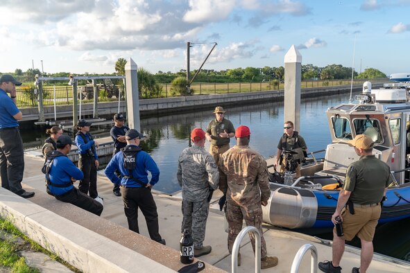 Department of the Air Force Police Lt. Todd C. Barrett, Officer in Charge of marine patrol, conducts a safety briefing for Airmen before they depart the marina on MacDill Air Force Base, Fla., July 2, 2019.