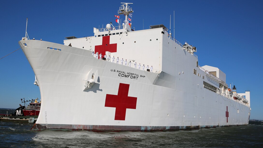 A view of the U.S. Navy Hospital Ship USNS Comfort, a white ship with two large red crosses displayed