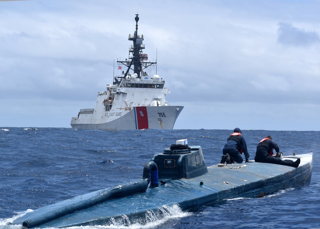 Coast Guard crew members inspect a self-propelled semi-submersible.