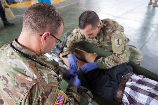 A doctor treats a patient.