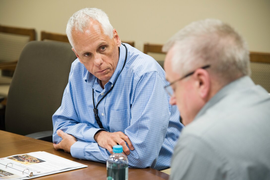 Ralph Campbell, the head of the Ordnance and Explosives Directorate at the U.S. Army Engineering and Support Center, Huntsville, Alabama, provides an organizational overview to Michael Schultz, the chief of Interagency and International Services Division with the U.S. Army Corps of Engineers’ Military Programs, during Schultz’s visit July 11.