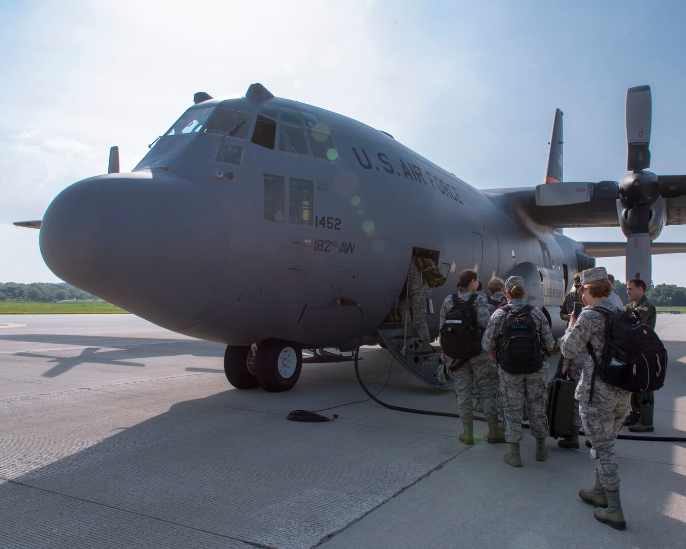 Airmen assigned to the 115th Fighter Wing, Madison, Wisconsin, board an Illinois Air National Guard C-130 Hercules for transport to New York July 9, 2019, for the Greater Chenango Cares and Healthy Cortland Innovative Readiness Training.