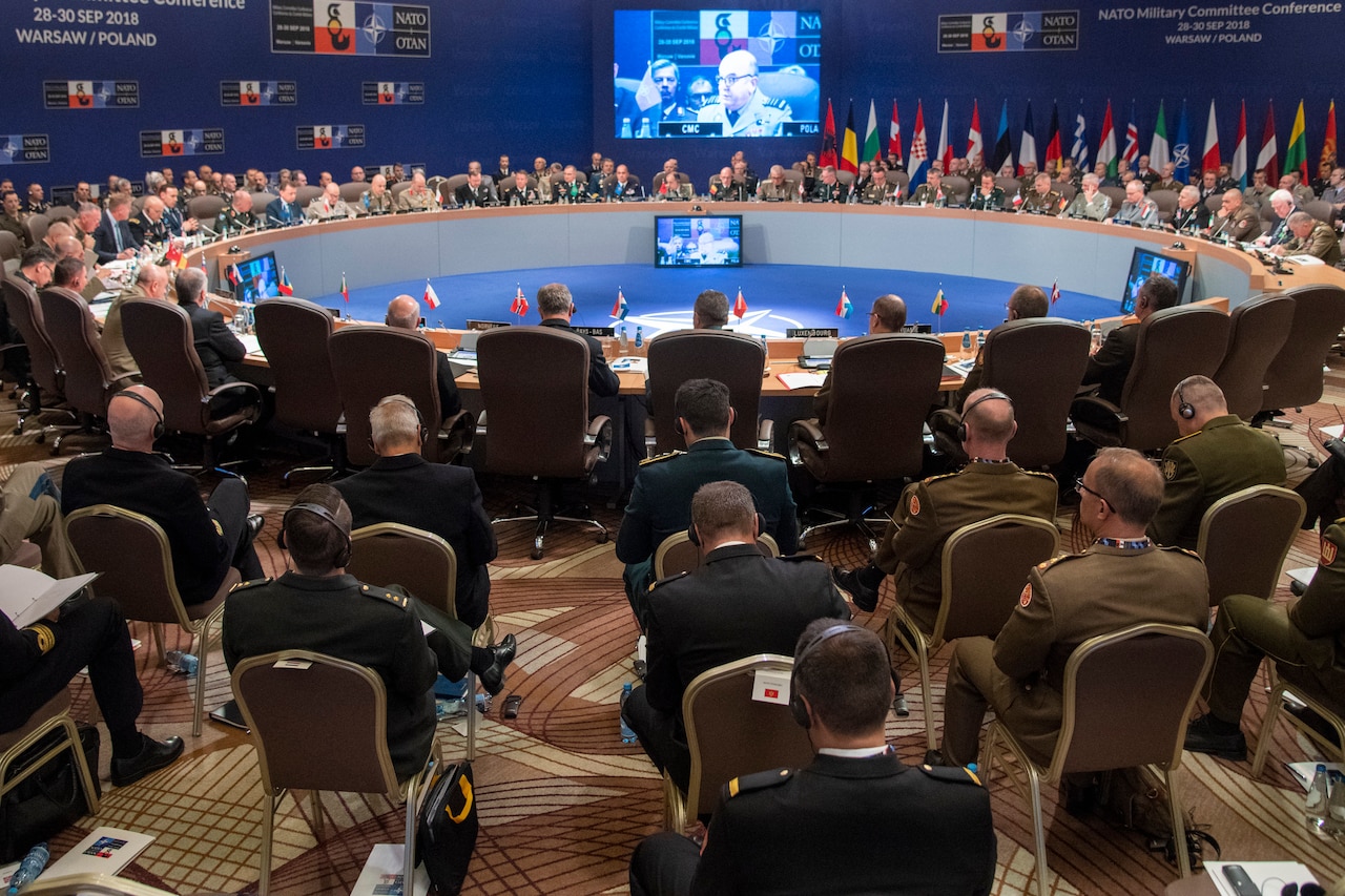 Generals sit around a large circular table.