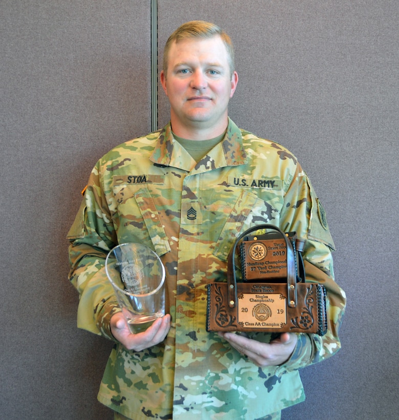 Sgt. 1st Class Brian Stoa, USAR Operations NCOIC for the Oklahoma City Recruiting Battalion and a champion shotgun shooter, poses with three of the trophies he’s already won in past three months.