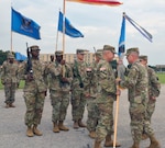 Col. Daniel Allen (left), 470th Military Intelligence Brigade incoming commander, accepts the brigade’s guidon from Maj. Gen. Gary Johnston, U.S. Army Intelligence and Security Command commanding general (right), during the brigade’s change of command ceremony at MacArthur Parade Field at Joint Base San Antonio-Fort Sam Houston July 9. Johnston was the presiding officer for the ceremony.