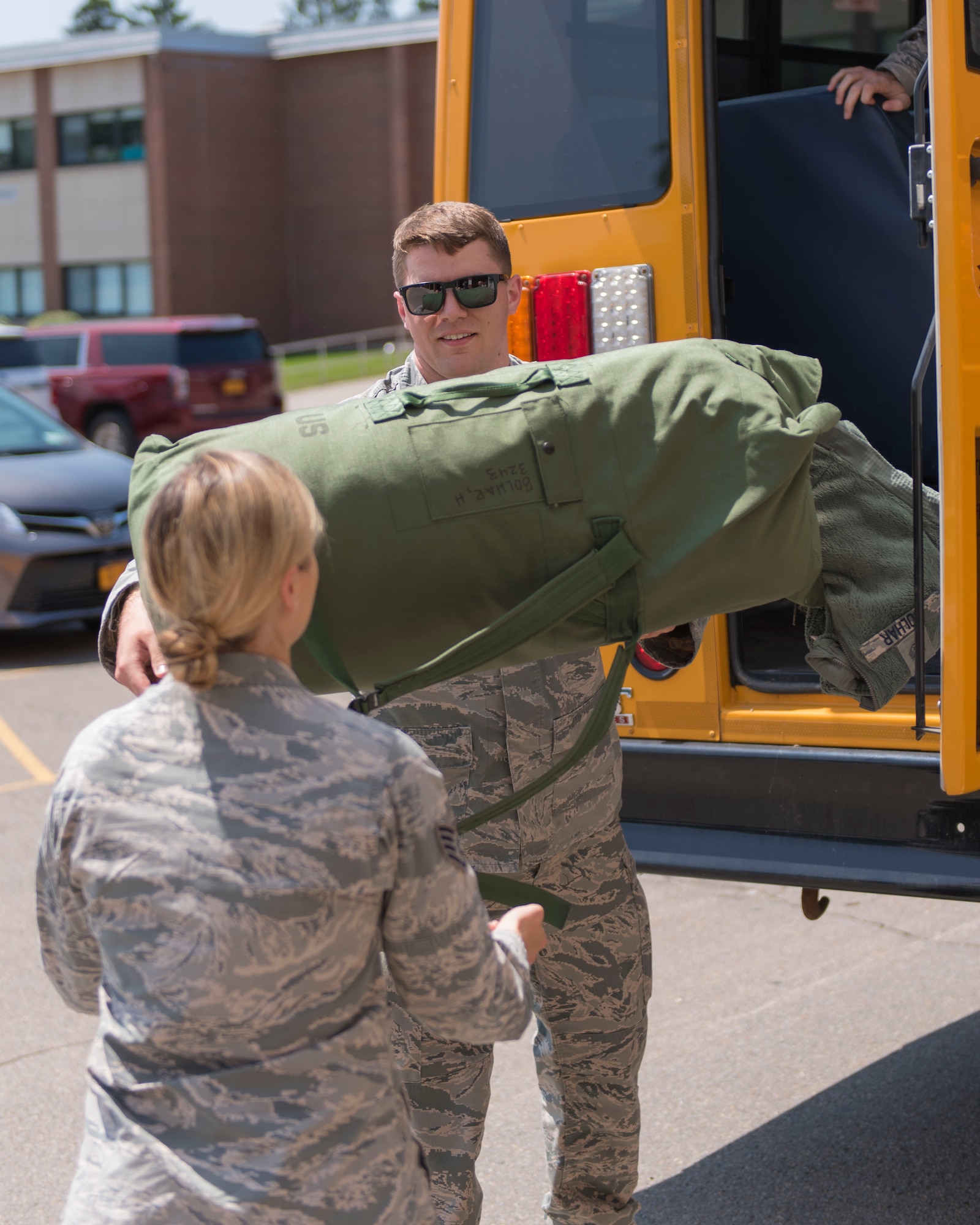 U.S. Air Force Tech Sgt. Kyle Henry, the NCO in charge of administration for the New York Innovative Readiness Training helps unload baggage July 9, 2019, after a group of Airmen arrived from Madison, Wisconsin. The Greater Chenango Cares and Healthy Cortland Innovative Readiness Training is comprised of Active Duty Air Force, Army, Navy, Reserves and National Guard troops working to bring no-cost health care and veterinary services to the underserved communities of Cortland and Chenango counties in New York. (U.S. Air National Guard photo by Airman 1st Class Cameron Lewis)