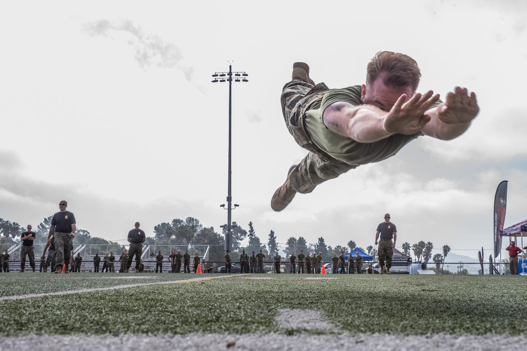 A Marine jumps through the air during a sporting event.