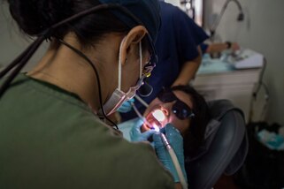 A dentist treats a patient.