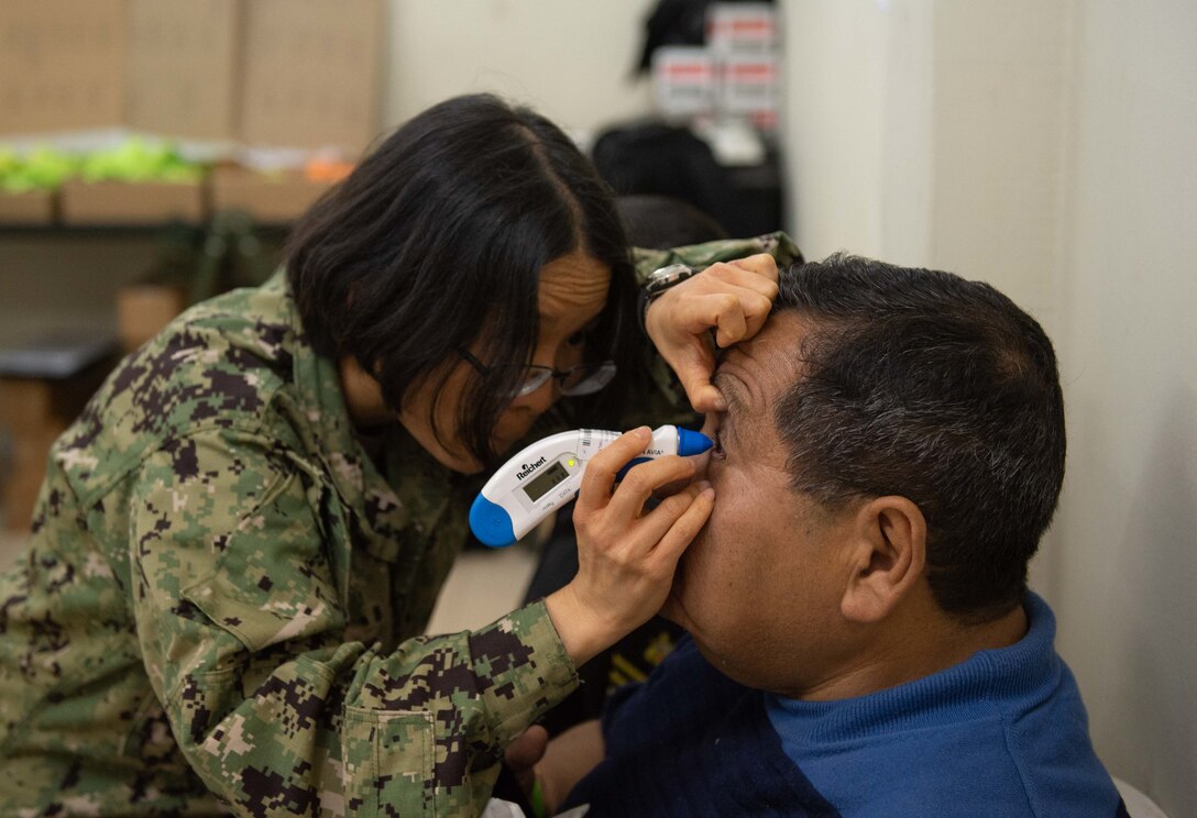 An optometrist examines a patient.