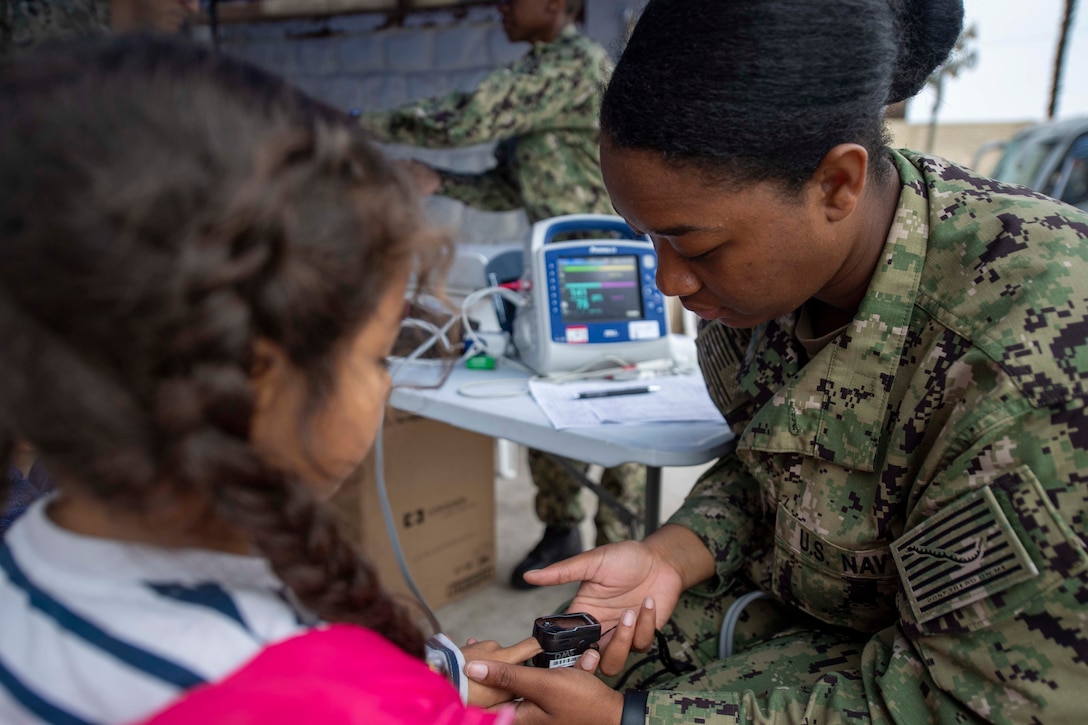 A doctor examines a patient.