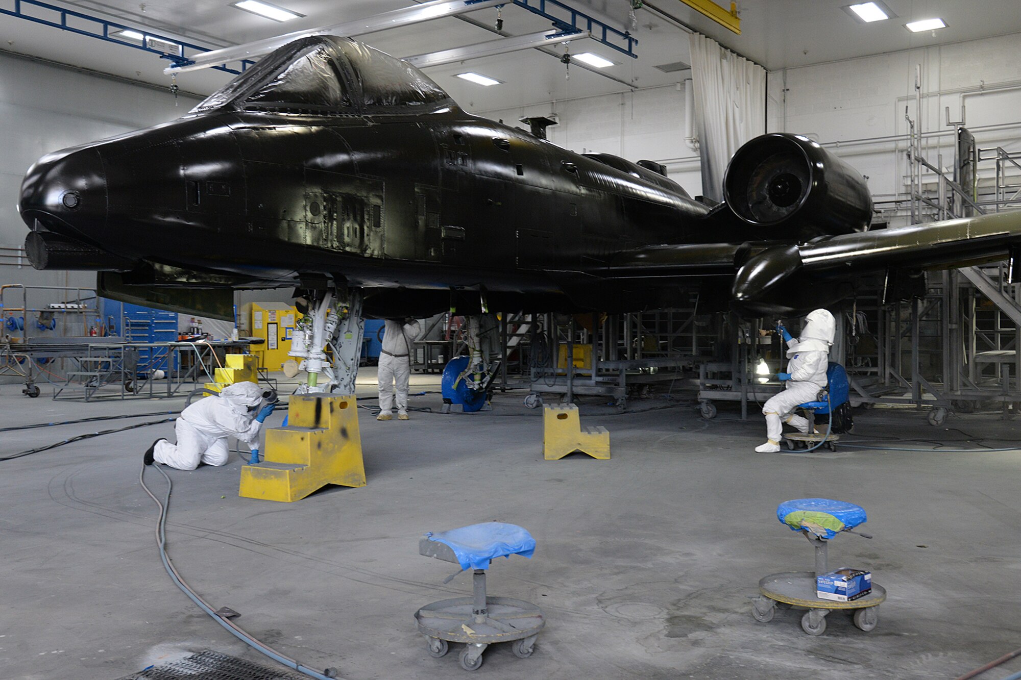 Corrosion control technicians apply primer to an A-10 Thunderbolt II