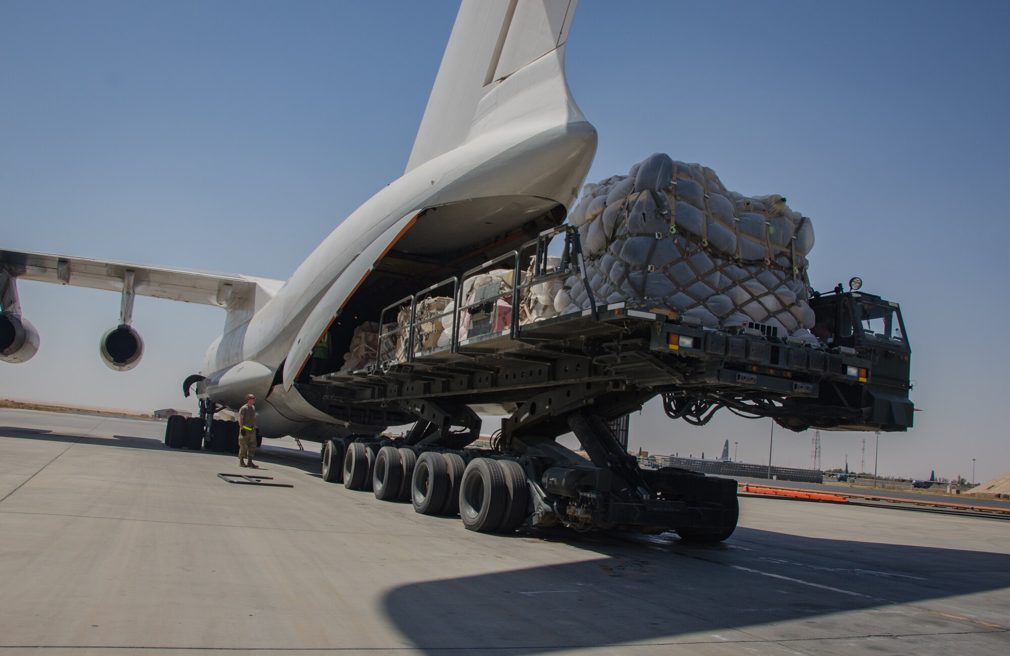 Airmen load a contracted Ilyushin IL-76 aircraft