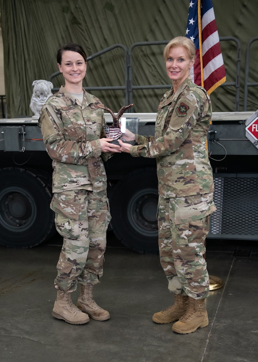 Col. Mary Decker (right), commander of the 123rd Mission Support Group, presents the Chief Master Sgt. Tommy Downs Award for Excellence in Aerial Port Operations to Tech. Sgt. Sarah Meyer during a ceremony at the Kentucky Air National Guard Base in Louisville, Ky., May 19, 2019. Meyer was selected from among more than 1,700 aerial porters as the top transportation journeyman in the Air National Guard for 2018. (U.S. Air National Guard photo by Master Sgt. Vicky Spesard)
