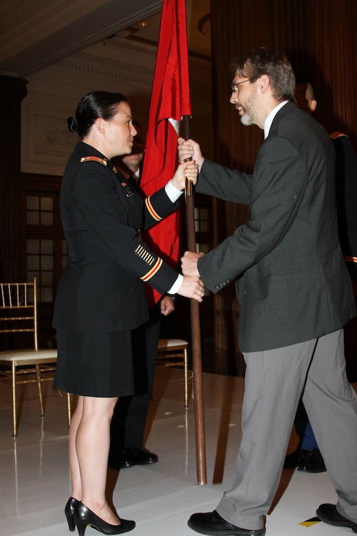 LTC Kristen N. Dahle (left) receives the colors from Deputy District Engineer Nate Barcomb during a July 12, 2019 Change of Command ceremony in the Wanamaker Building. LTC David C Park assumed command of the organization during the ceremony.