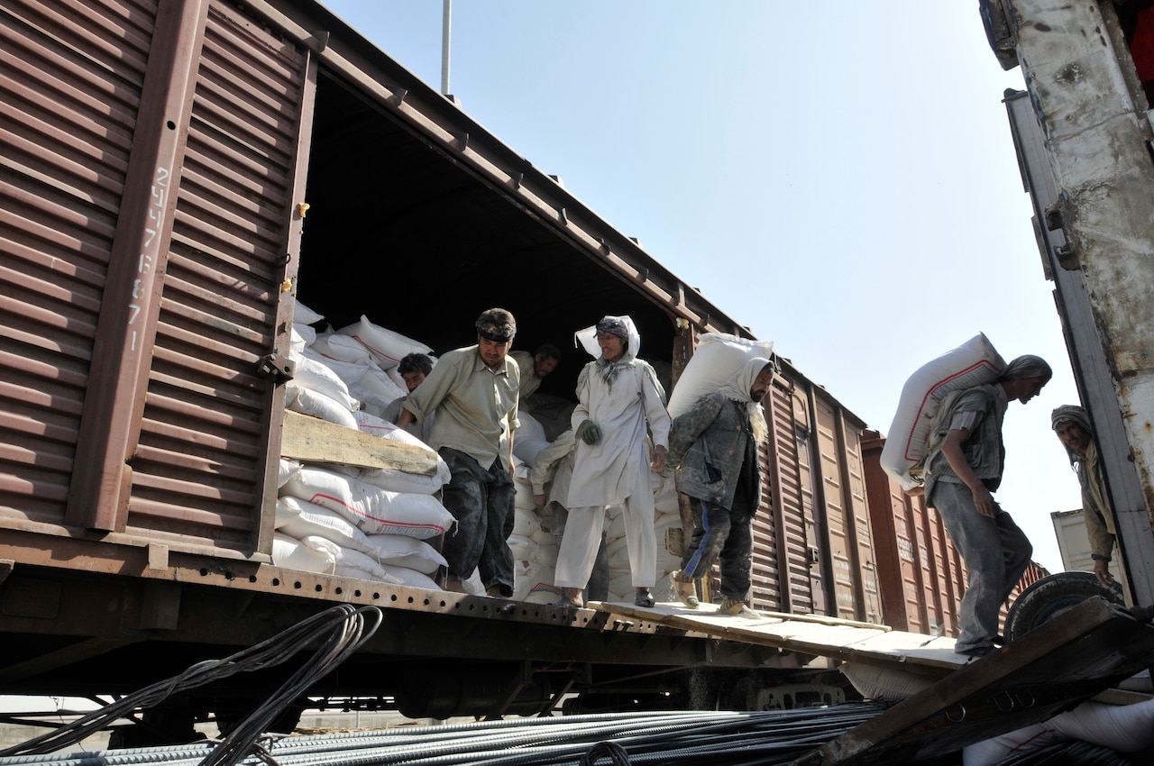 People offload boxcar