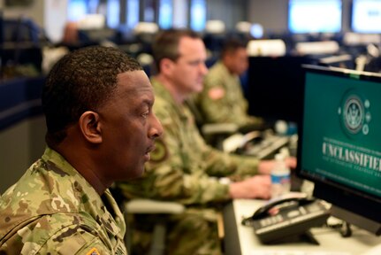 Army Master Sgt. Mark McCray reviews and updates information at the National Guard Coordination Center in Arlington, Virginia, July 12, 2019. McCray is serving in the NGCC during the National Guard’s response to Tropical Storm Barry.