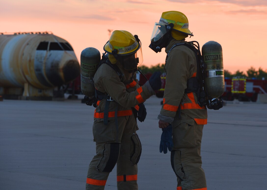 U.S. Air Force Airman Jared Moritz, 312th Training Squadron student, double checks the fire protection gear of U.S. Army Pfc. Jacob Clavesilla, 169th Engineer Battalion student, before Clavesilla enters a burning area outside the Louis F. Garland Department of Defense Fire Academy on Goodfellow Air Force Base, Texas, July 11, 2019. As part of Goodfellow’s joint mission, this specific course educates 10 Air Force students, three Army students, one Navy student, and one Coast Guard student in a consolidated learning environment. (U.S. Air Force Photo by Airman 1st Class Abbey Rieves/Released)
