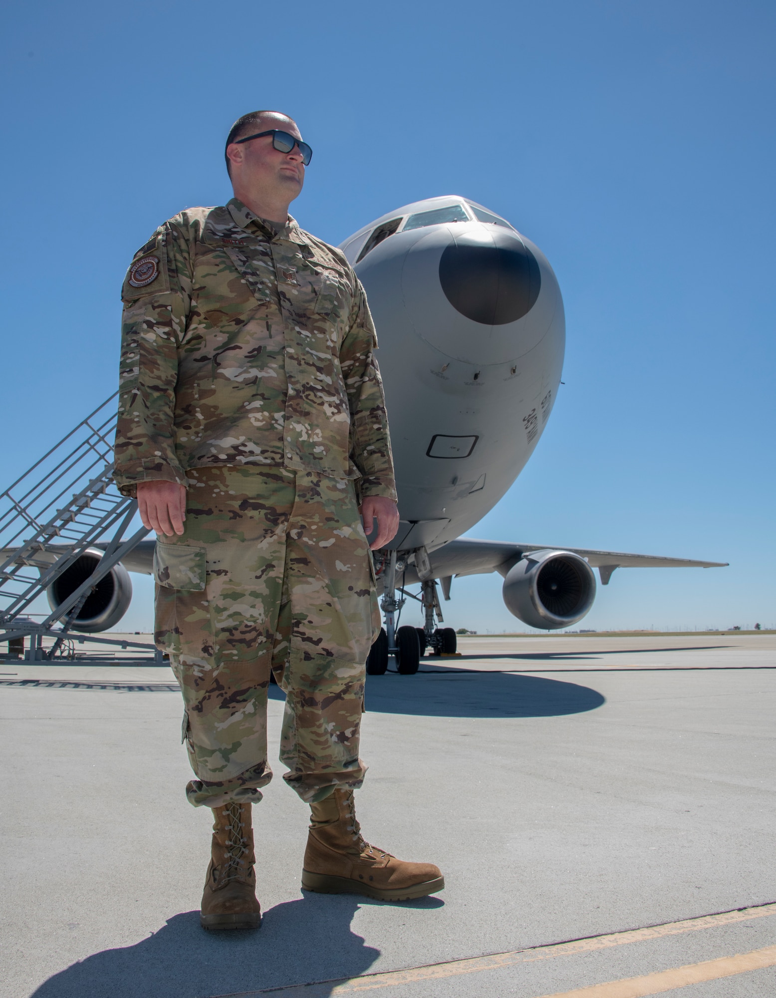 U.S. Air Force Tech. Sgt. Matthew Smith, 660th Aircraft Maintenance Squadron flying crew chief, stands in front of a KC-10 Extender prior to takeoff July 11, 2019, at Travis Air Force Base, California. FCCs are responsible for a wide variety of maintenance duties while traveling with the aircraft including refueling, paperwork, routine maintenance and troubleshooting major issues. (U.S. Air Force photo by Heide Couch)