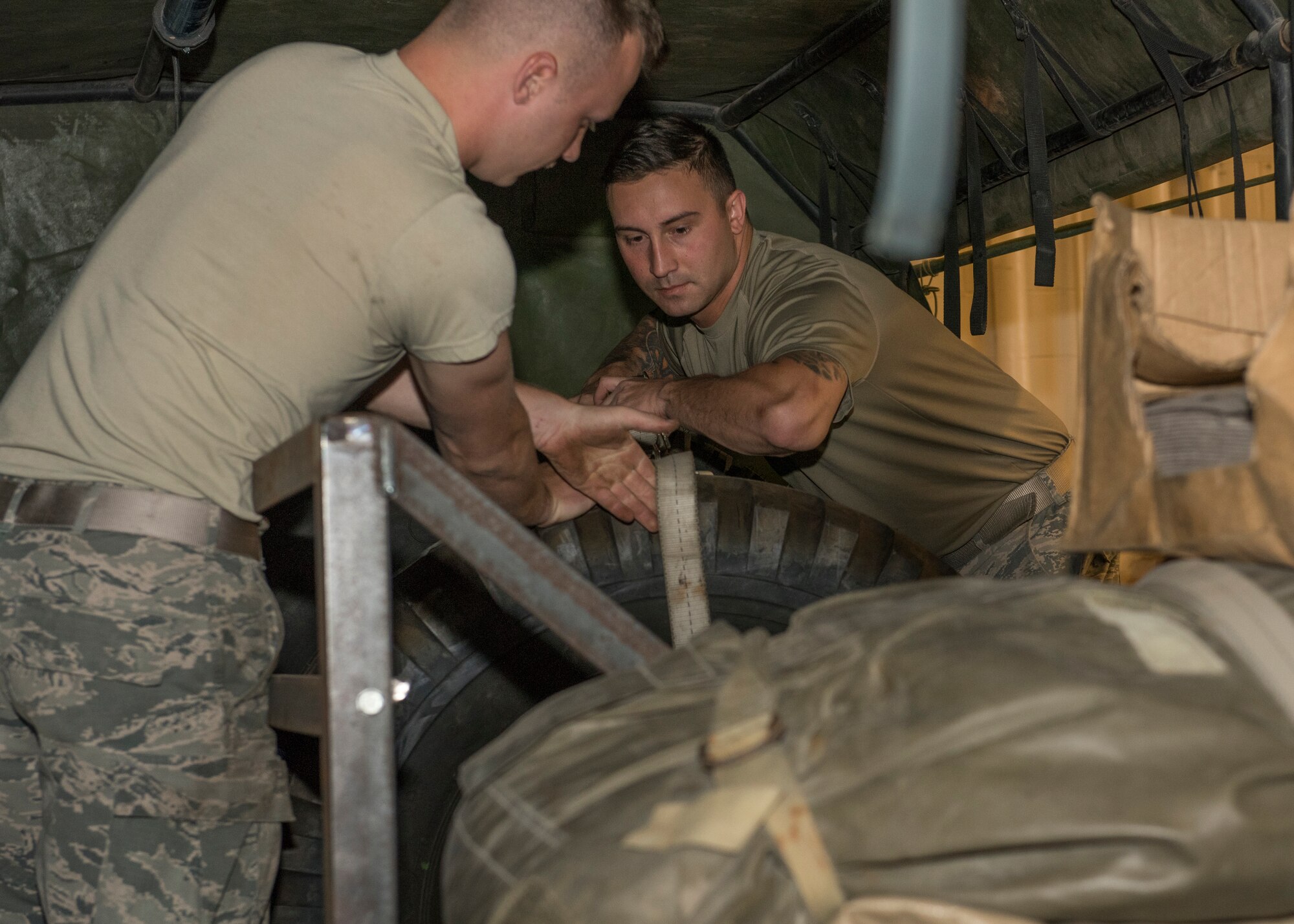 Senior Airman Taylor Duggar, 726th Air Control Squadron, strips down tires stores on an Medium Tactical Vehicle July 9, 2019, at Mountain Home Air Force Base. Cargo placed insdie of MTVs is secured to increase safety during travel. (U.S Air Force photo by Senior Airman Tyrell Hall)