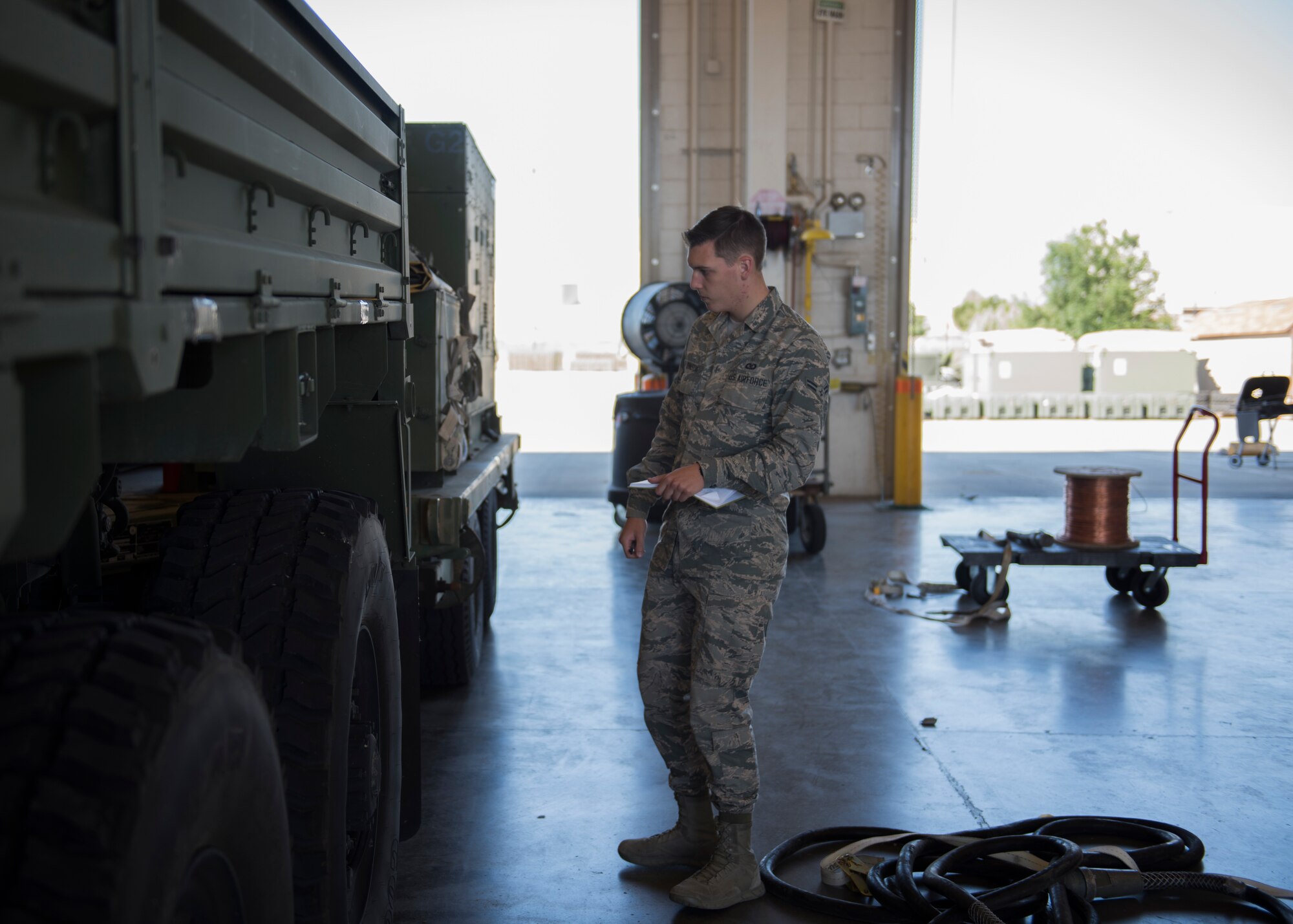 Airman 1st Class  Nicolas Johnson, 726th Air Control Squadron, inspects a Medium Tactical Vehicle in preparation for a 726th ACS deployment exercise July 11, 2019, at Mountain Home Air Force Base, Idaho. His job is to make sure the weight calculations adhere to standards. (U.S. Air Force photo by Senior Airman Tyrell Hall)